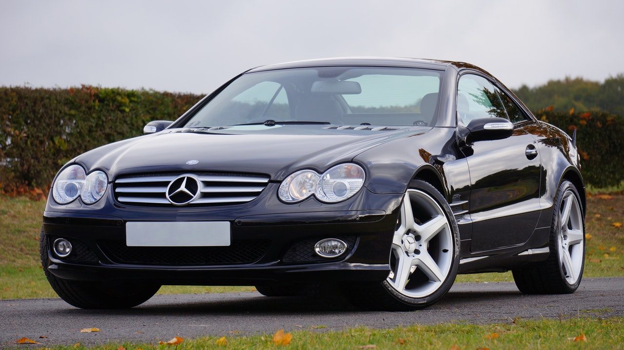 A black coupe parked on grass