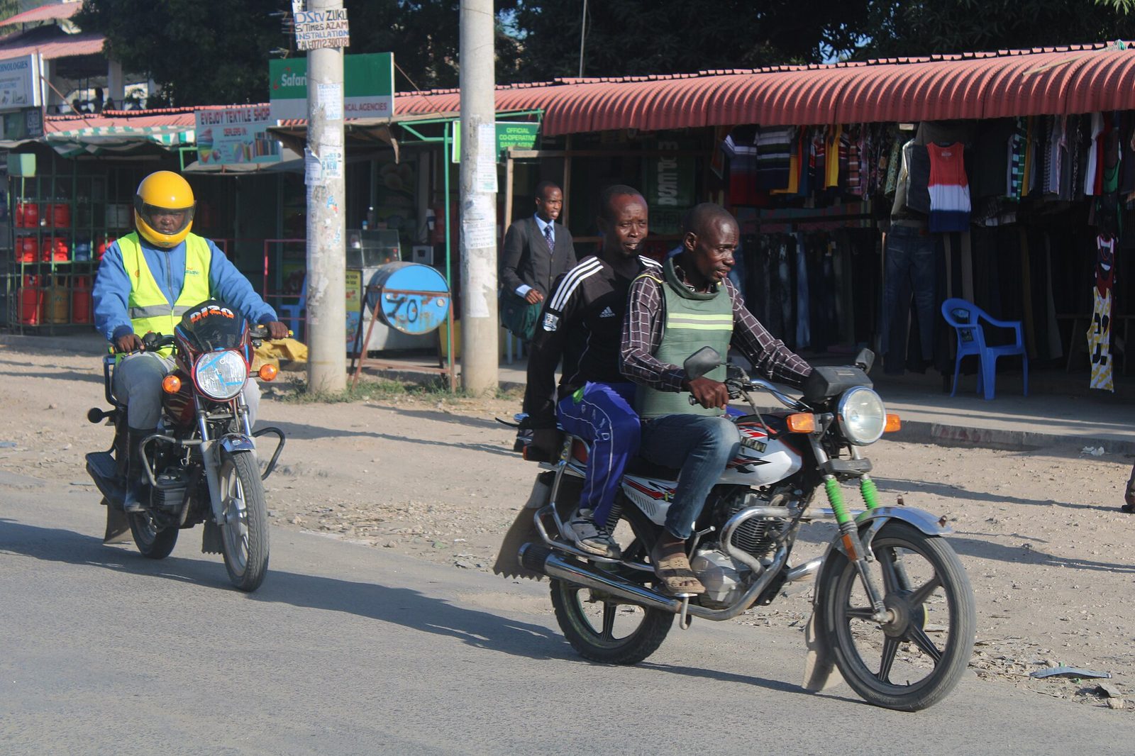 A boda boda rider carrying a passenger in Likoni, Mombasa