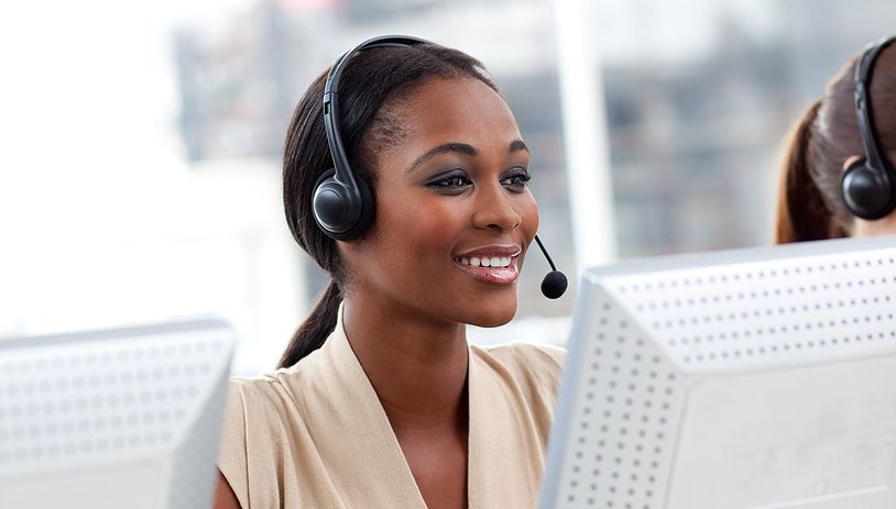 A smiling Kenyan call-centre agent wearing a headset