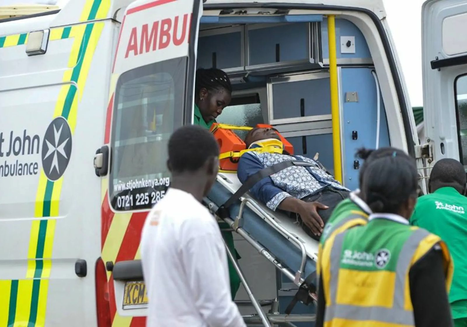 Paramedics loading a patient into a St John Ambulance vehicle