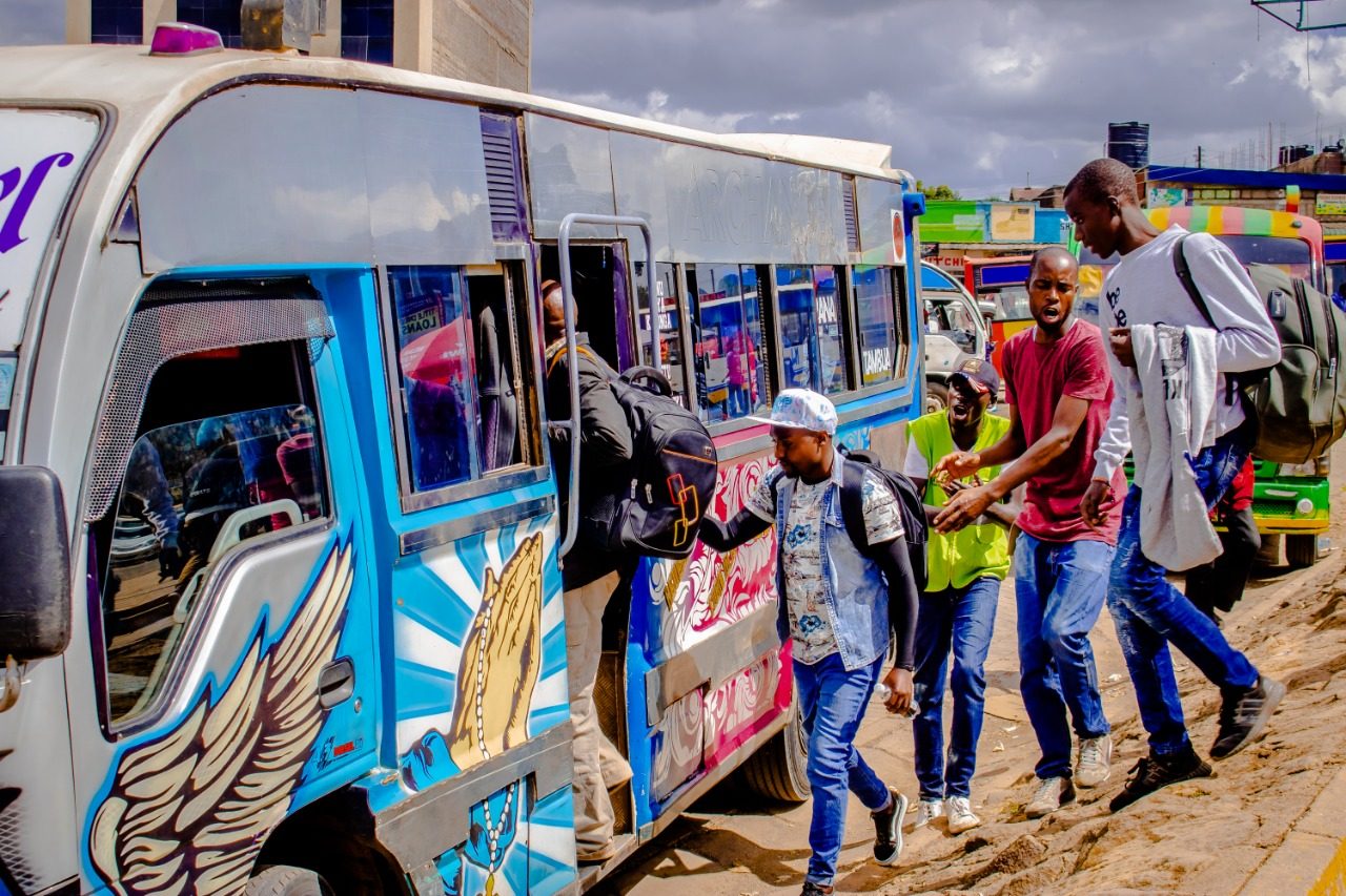 Passengers boarding a colourful matatu in Nairobi