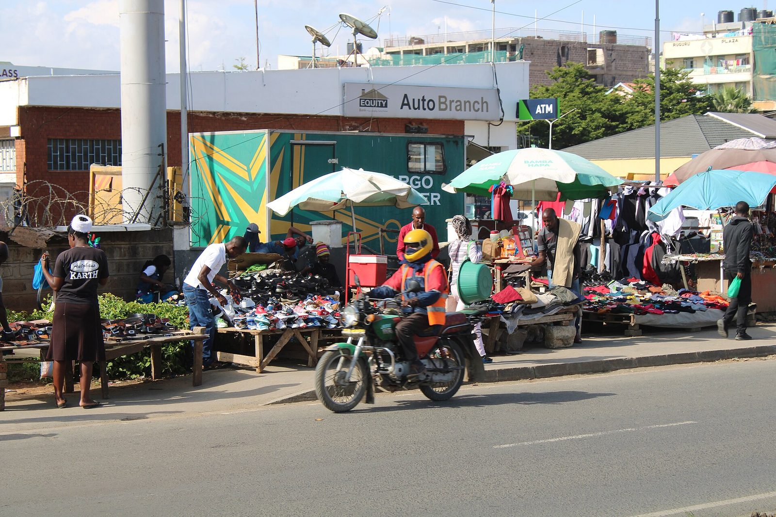 Boda boda riders waiting at a stage on a Nairobi street