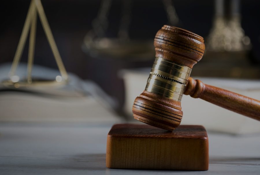 A judge's gavel resting on a wooden desk