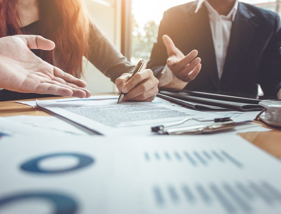 An advisor reviewing insurance documents with a client