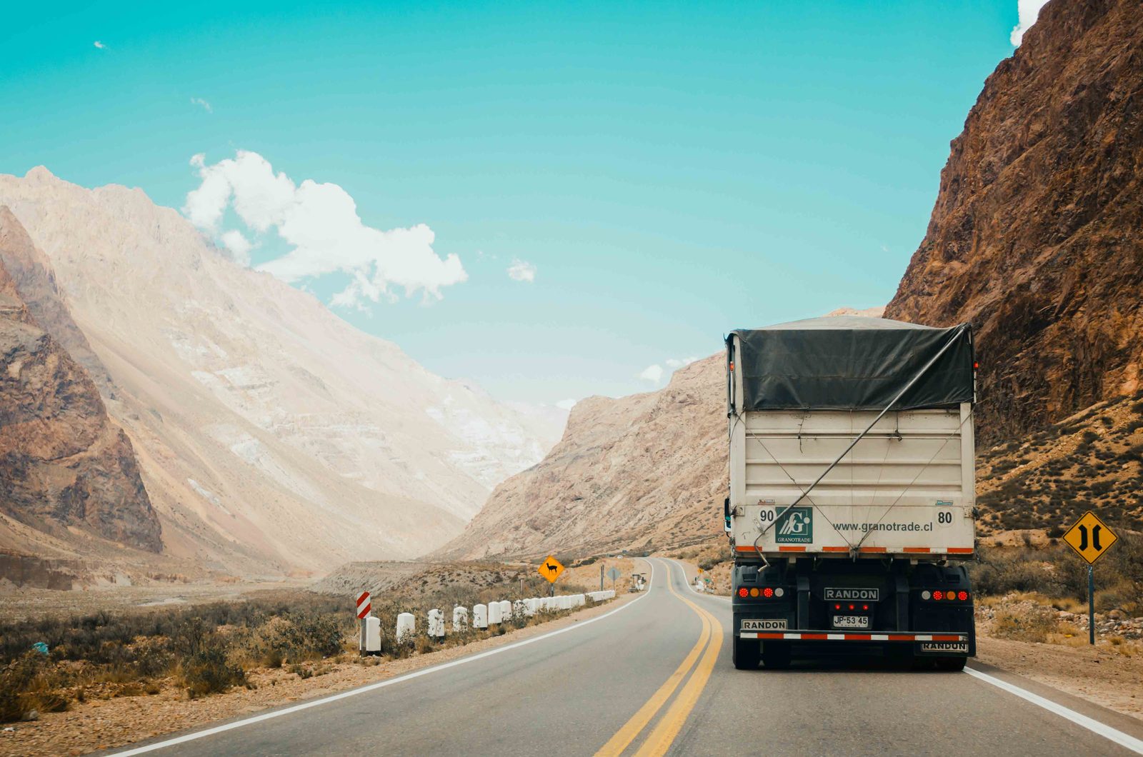 A loaded lorry driving on an open Kenyan highway